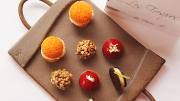 A tray with various desserts and a box labeled "Les Frigues".