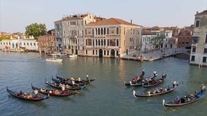 Gondolas on a canal in a historic city. - Palazzetto Pisani (Venice)