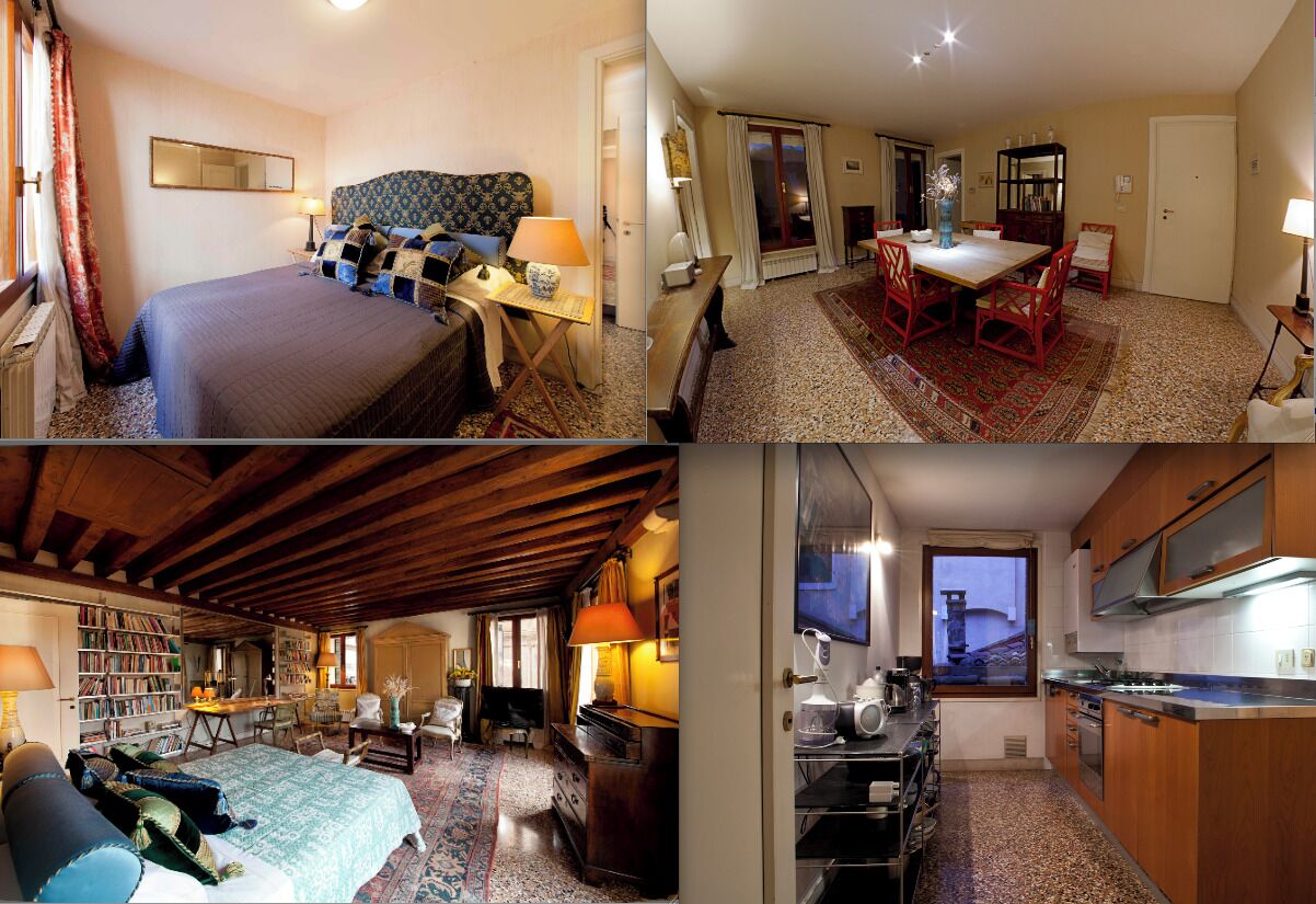 A hotel room with a bed, bedside table, lamp, and a view of the dining area.