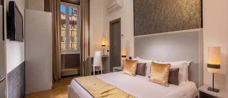 A modern hotel room with a large bed, bedside lamps, a flat-screen TV, and a view of the city through the window.