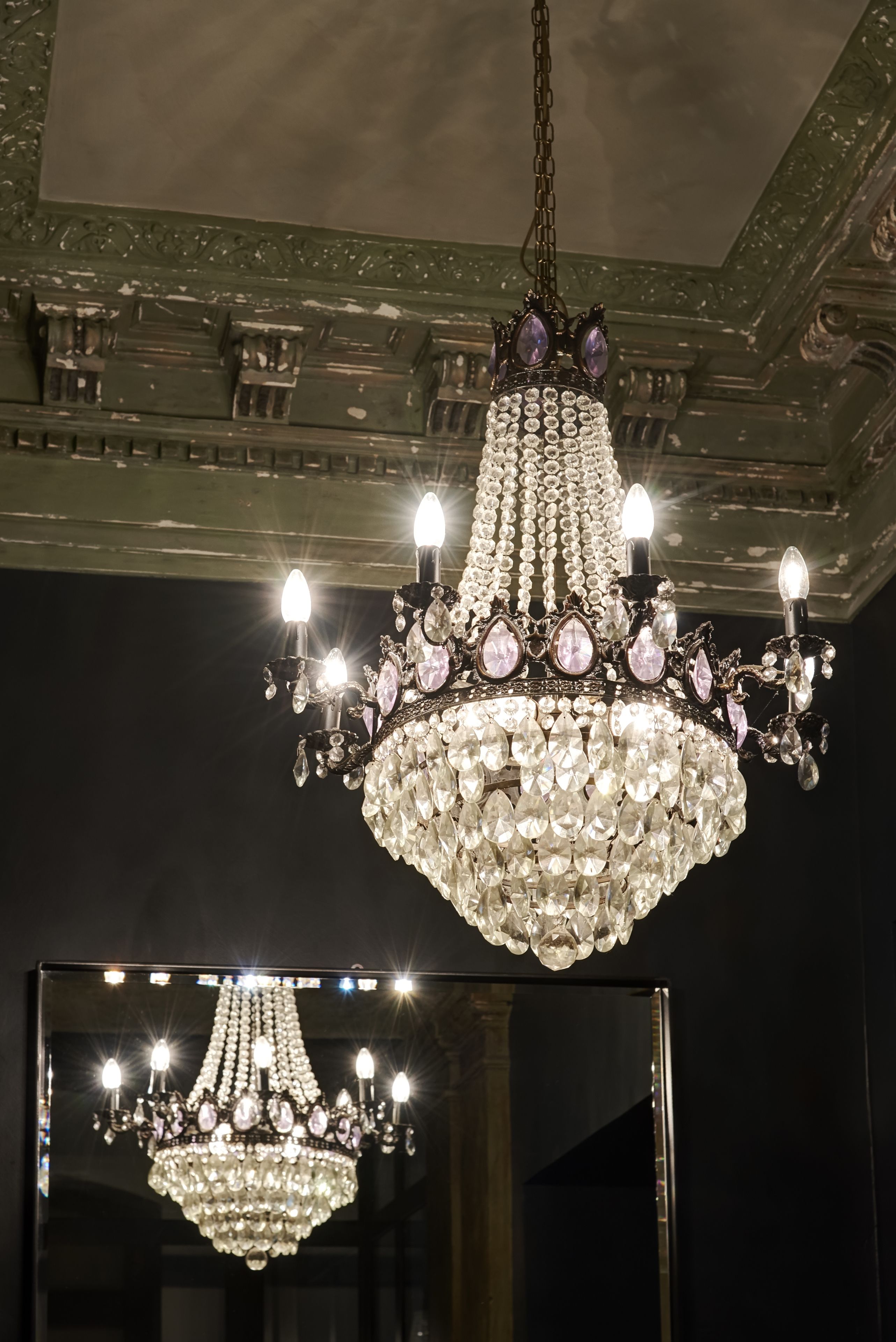 A chandelier with multiple lights and crystal decorations.