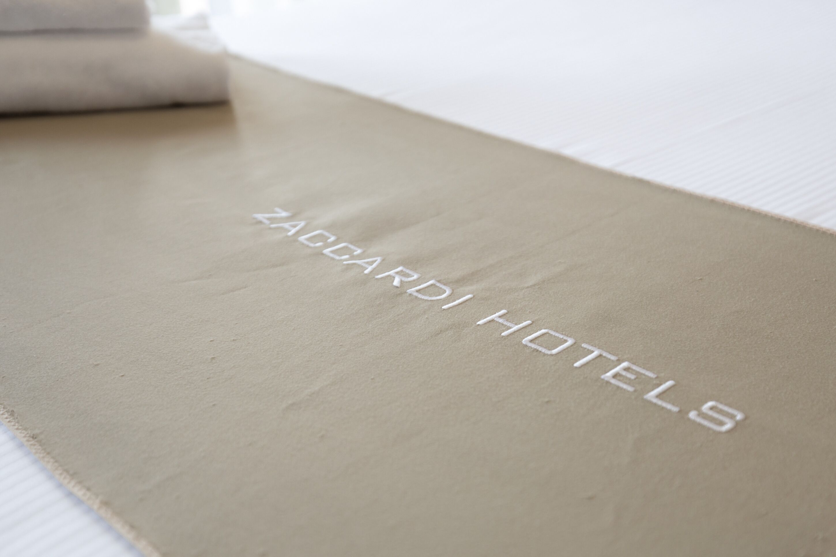A beige envelope with "ZACCARDI HOTELS" embossed on it.