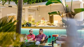 A restaurant with a counter and seating area.