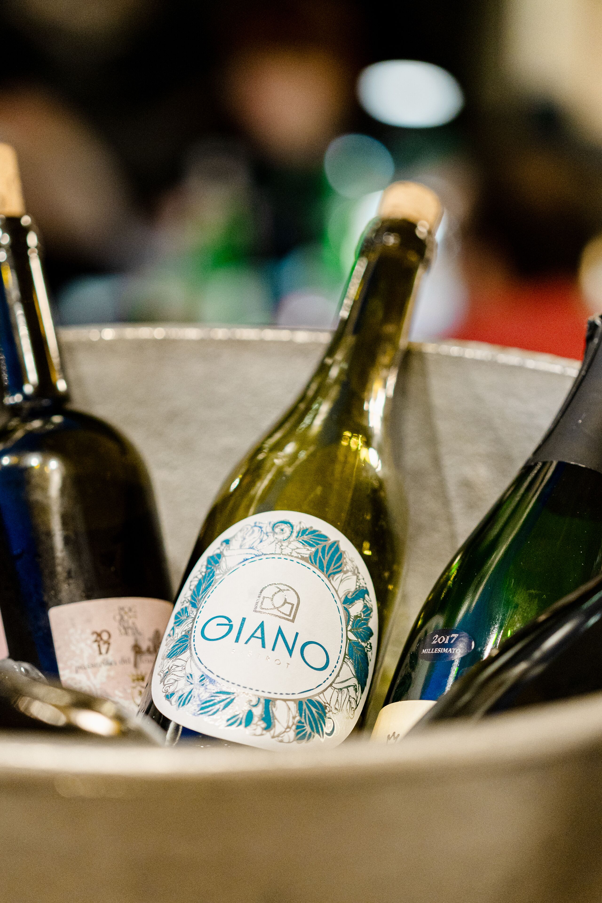 A bottle of wine with a label in a container.