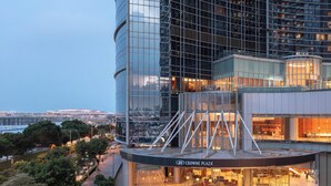 A modern building with a glass facade, a landscaped area with a circular garden, and a sign reading "Crowne Plaza". - Crowne Plaza Macau by IHG (Macau)