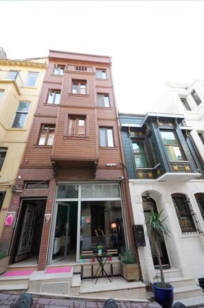 A multi-story building with a ground-floor entrance, large windows, and a visible balcony. - Suite Dreams Istanbul (Istanbul)