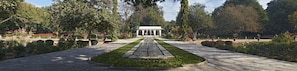 A symmetrical garden with a central water feature, pathways, and a white pavilion. - Samode Bagh (Chomu)