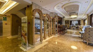 A spacious lobby with marble flooring, ornate columns, and a seating area with a patterned sofa. - Euro Stars Hotel Old City (Istanbul)