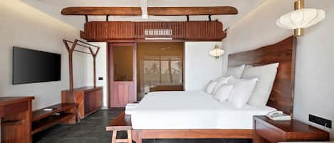 A modern bedroom with a large bed, wooden headboard, a TV mounted on the wall, and a balcony with a wooden railing.