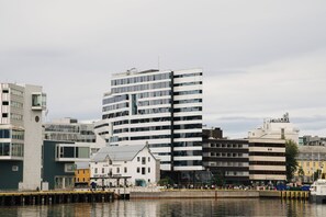 A waterfront hotel with a modern design, featuring multiple floors and a prominent corner location. - Clarion Hotel The Edge (Tromsø)