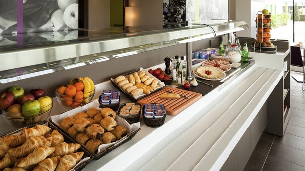 A buffet with various food items including fruits, pastries, and condiments. - ibis Styles Lleida Torrefarrera (Torrefarrera)