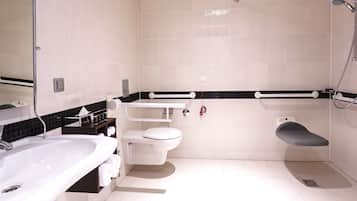 A modern bathroom with a white sink, toilet, and shower.