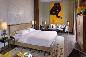 A hotel room with a large bed, bedside tables, a desk, and a sofa. - Jinmao Purelax Chongming (Shanghai)
