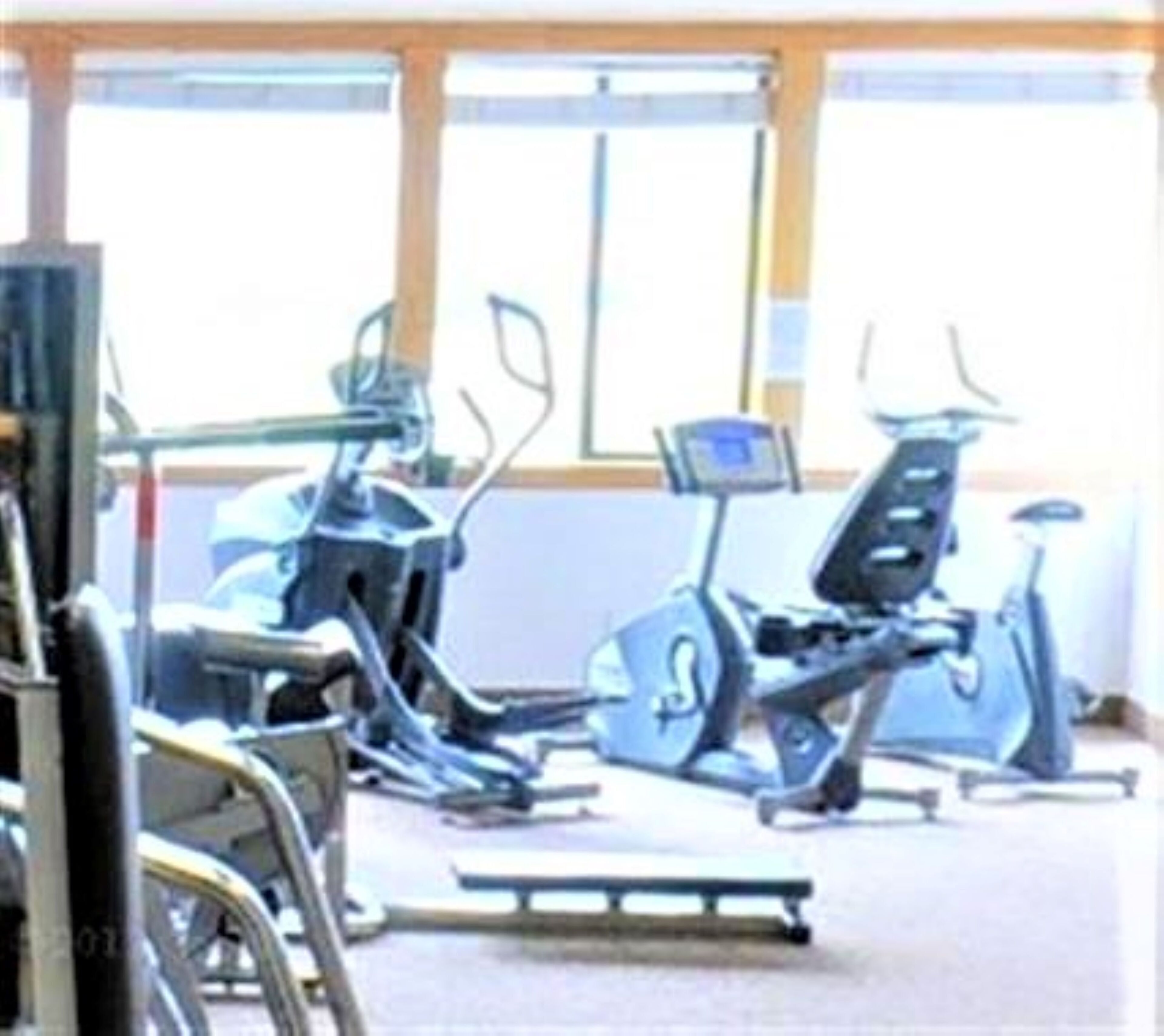 A gym with stationary bikes and treadmills.