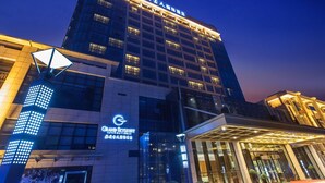 A hotel with a modern facade, featuring illuminated signage and a prominent entrance. - Grand Skylight International Hotel Guiyang (Guiyang)