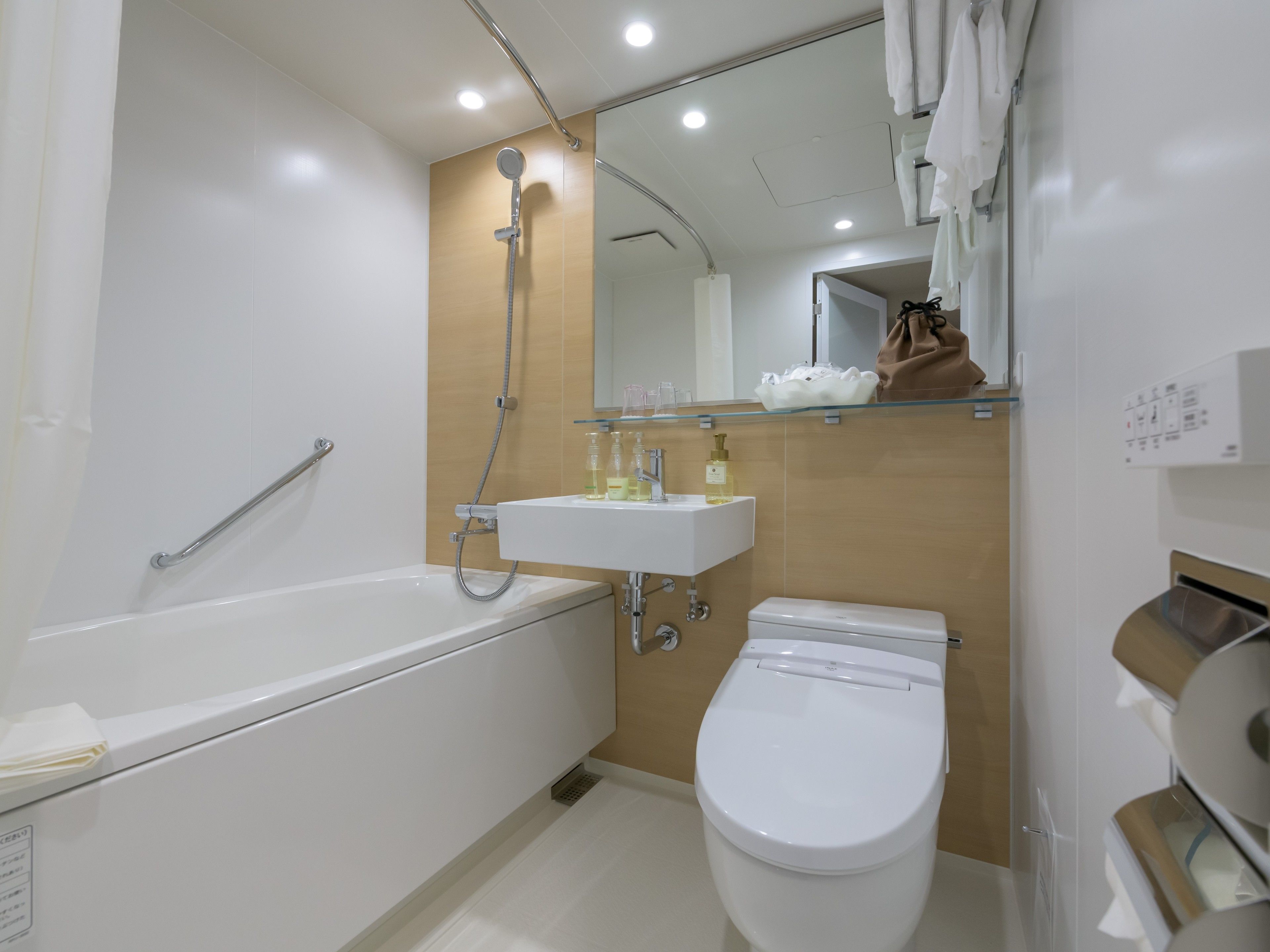 A modern bathroom with a bathtub, toilet, and sink.
