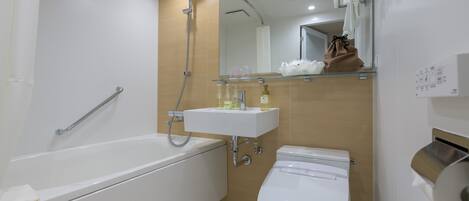 A modern bathroom with a bathtub, toilet, and sink.