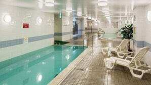 An indoor swimming pool with clear water, tiled walls, and lounge chairs along the poolside. - Nara Royal Hotel (Nara)