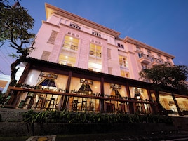 A multi-story hotel with a traditional architectural style, featuring large windows and balconies.