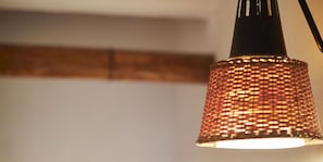 A close-up of a textured, copper-colored lamp with a black base. - Guest House Kikusui Ryokan (Tamano)