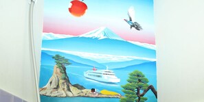 A mural with a ship, a bird, and a person on a cliff. - Guest House Kikusui Ryokan (Tamano)
