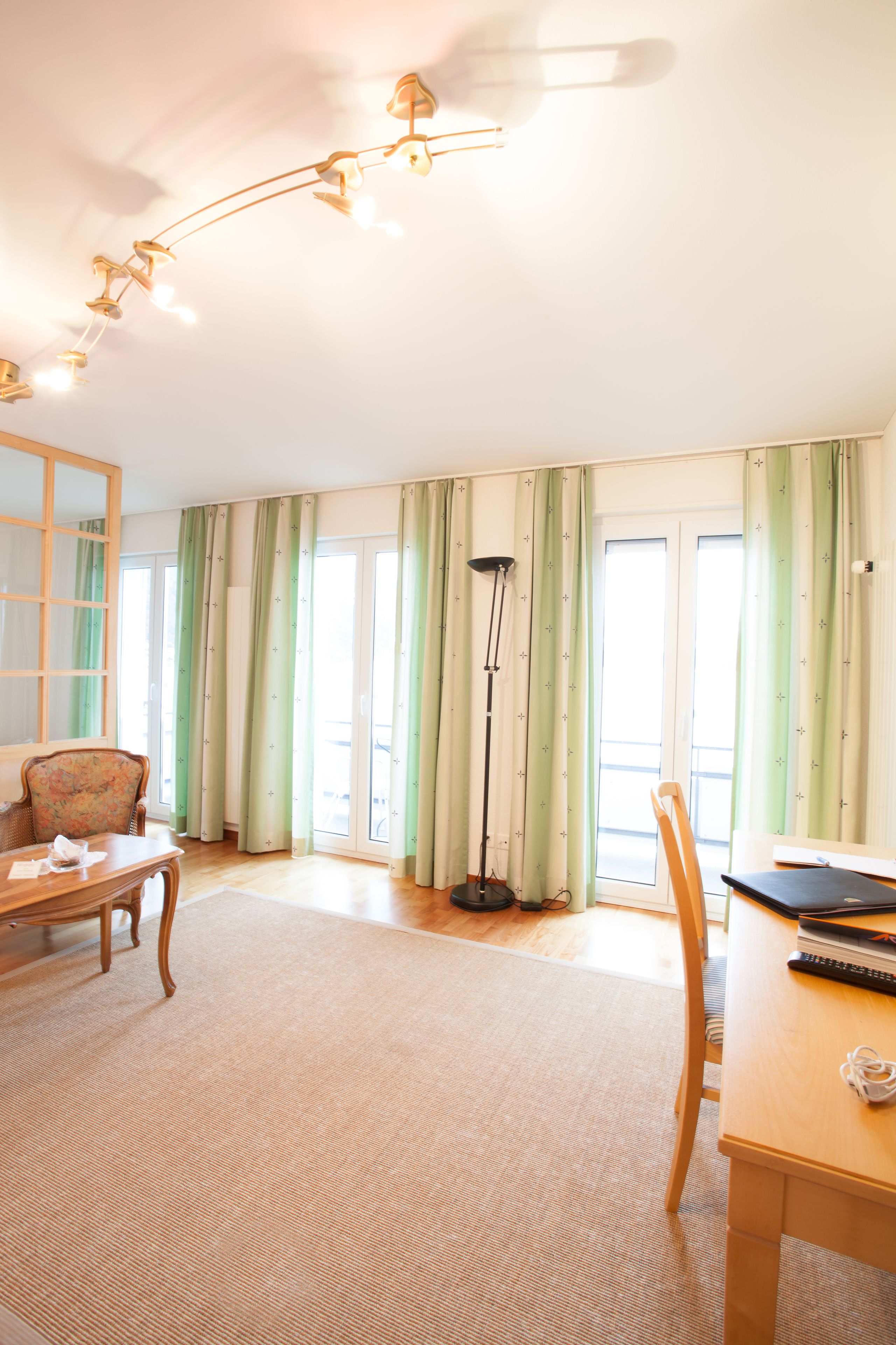 junior suite | living area | flat-screen tv, heated floors