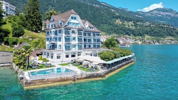 A large, multi-story hotel with a pool on a lakeside property. - Hotel Central am See (Weggis)