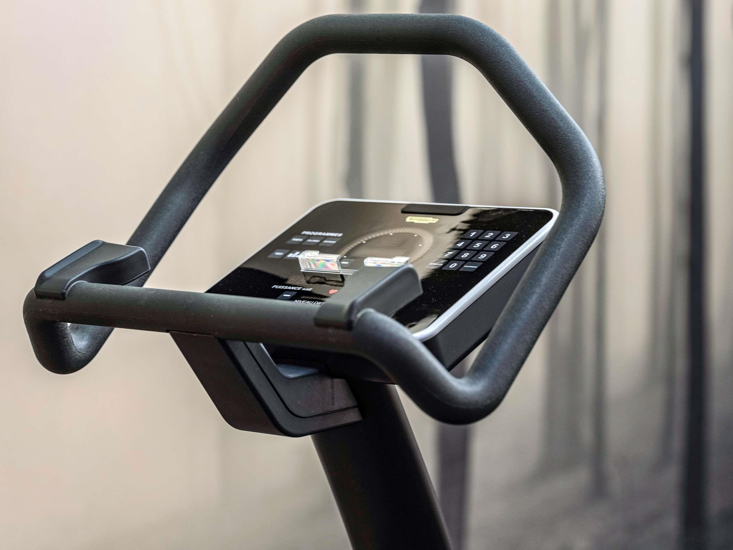 A stationary exercise bike with a digital display and control panel.