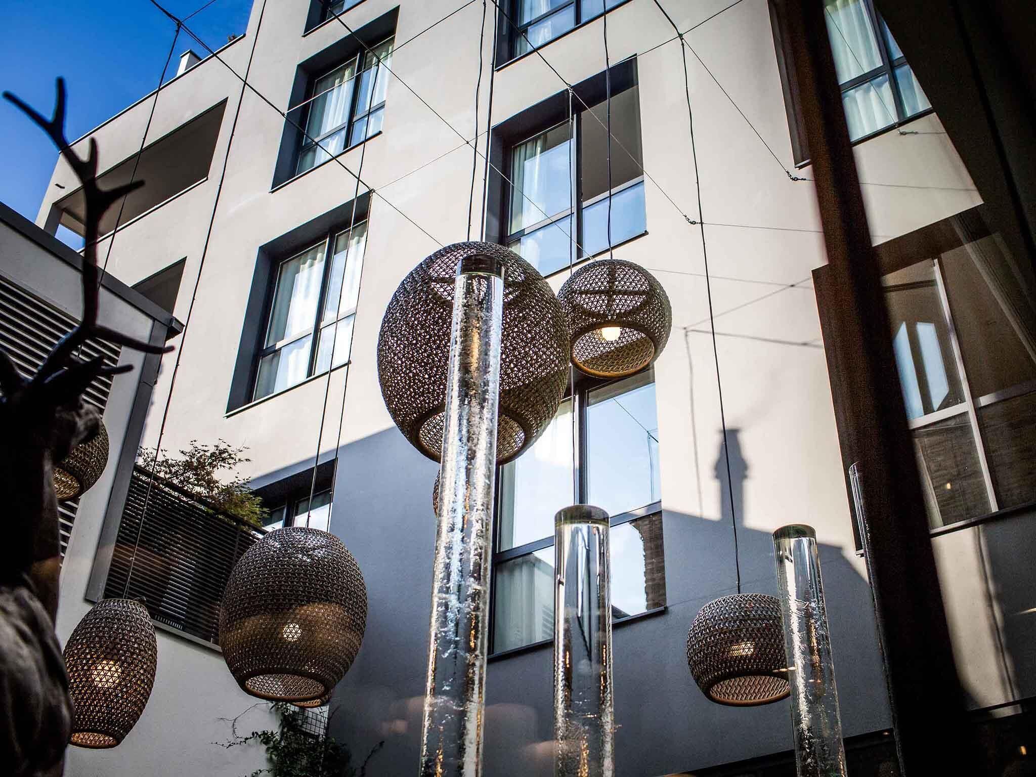 A modern building with large windows and spherical hanging lights.