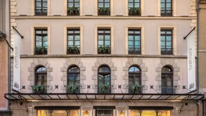 A hotel facade with multiple windows, some with plants, and a sign reading "balhazar hotel." - Balthazar Hotel & Spa Rennes - MGallery Collection (Rennes)