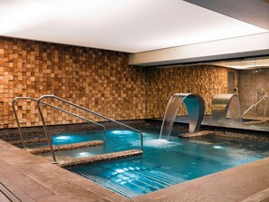 A pool area with a waterfall feature, metal railings, and a tiled wall. - Balthazar Hotel & Spa Rennes - MGallery Collection (Rennes)