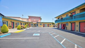 A parking lot with marked handicapped spaces, a Cost Plus World Market store, and a van accessible entrance. - Seaside Inn (Seaside)