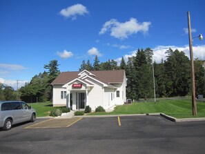 A small white building with a sign that reads "OFFICE" on the front.