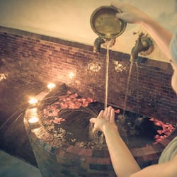 Guests can enjoy a soothing bathing experience with a traditional water feature.