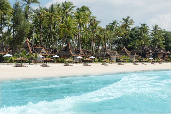 Am Strand, Sonnenschirme, Strandtücher, Volleyball