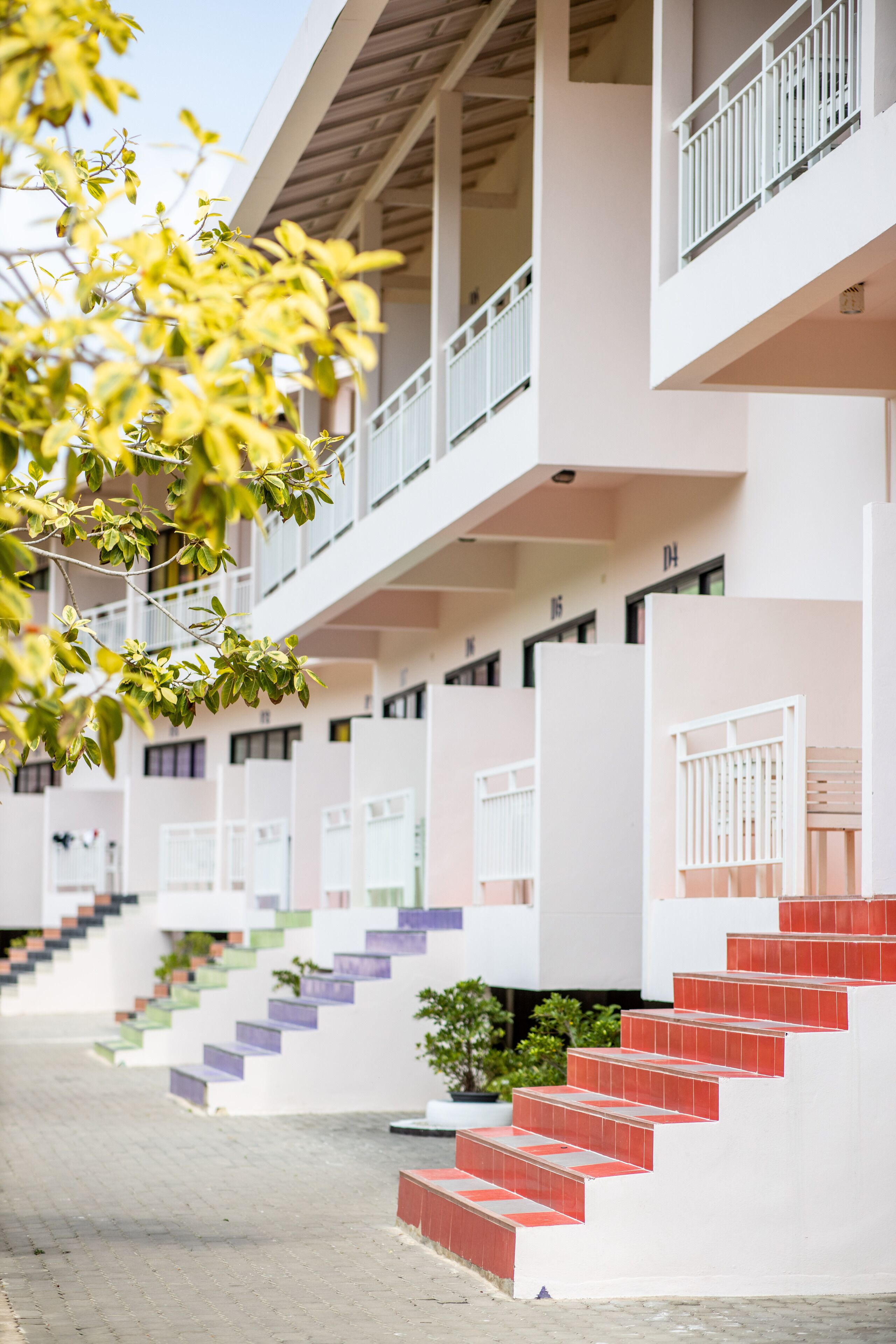 A multi-story building with a series of balconies and staircases.