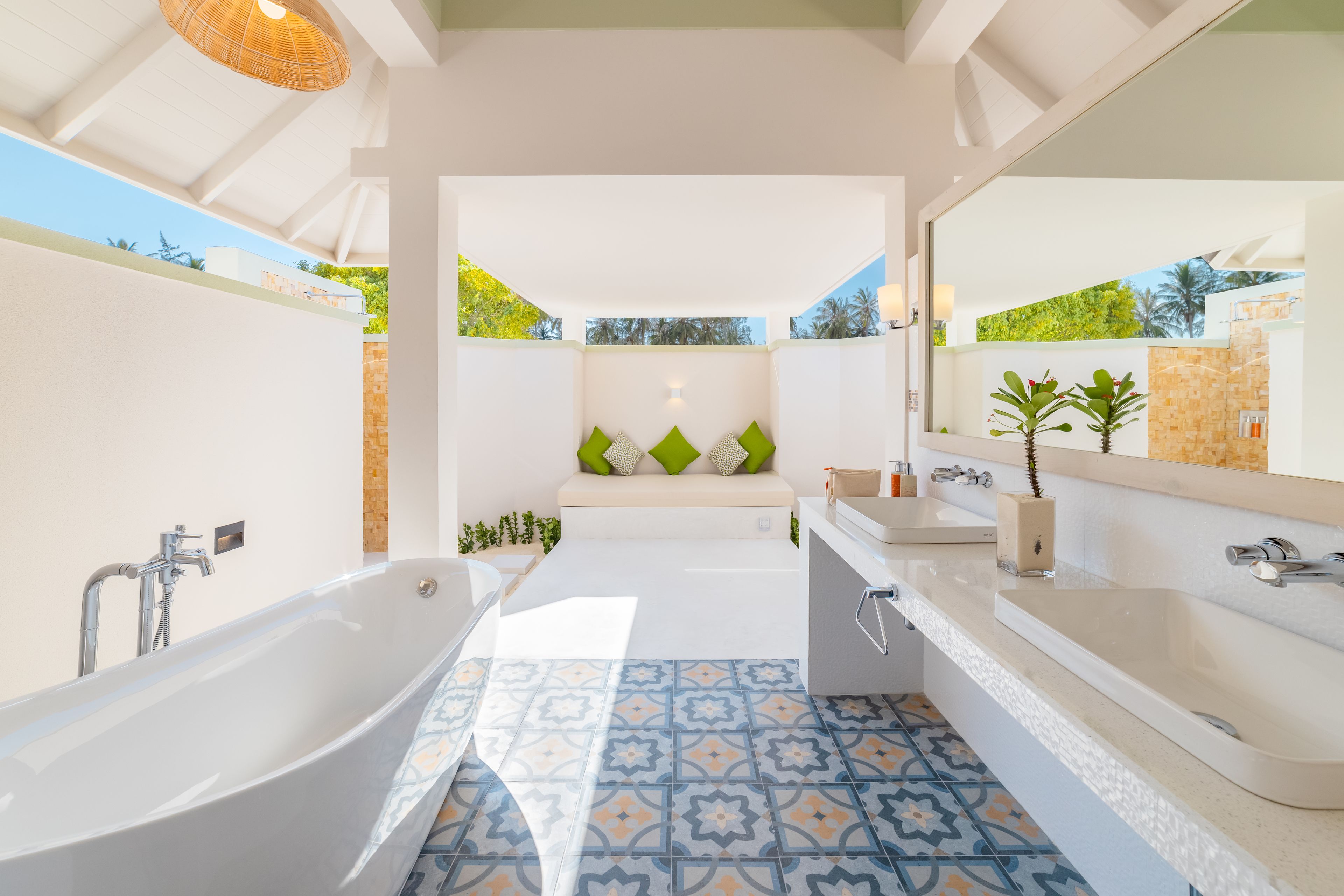 A modern bathroom with a freestanding bathtub, a large mirror, and a sink.
