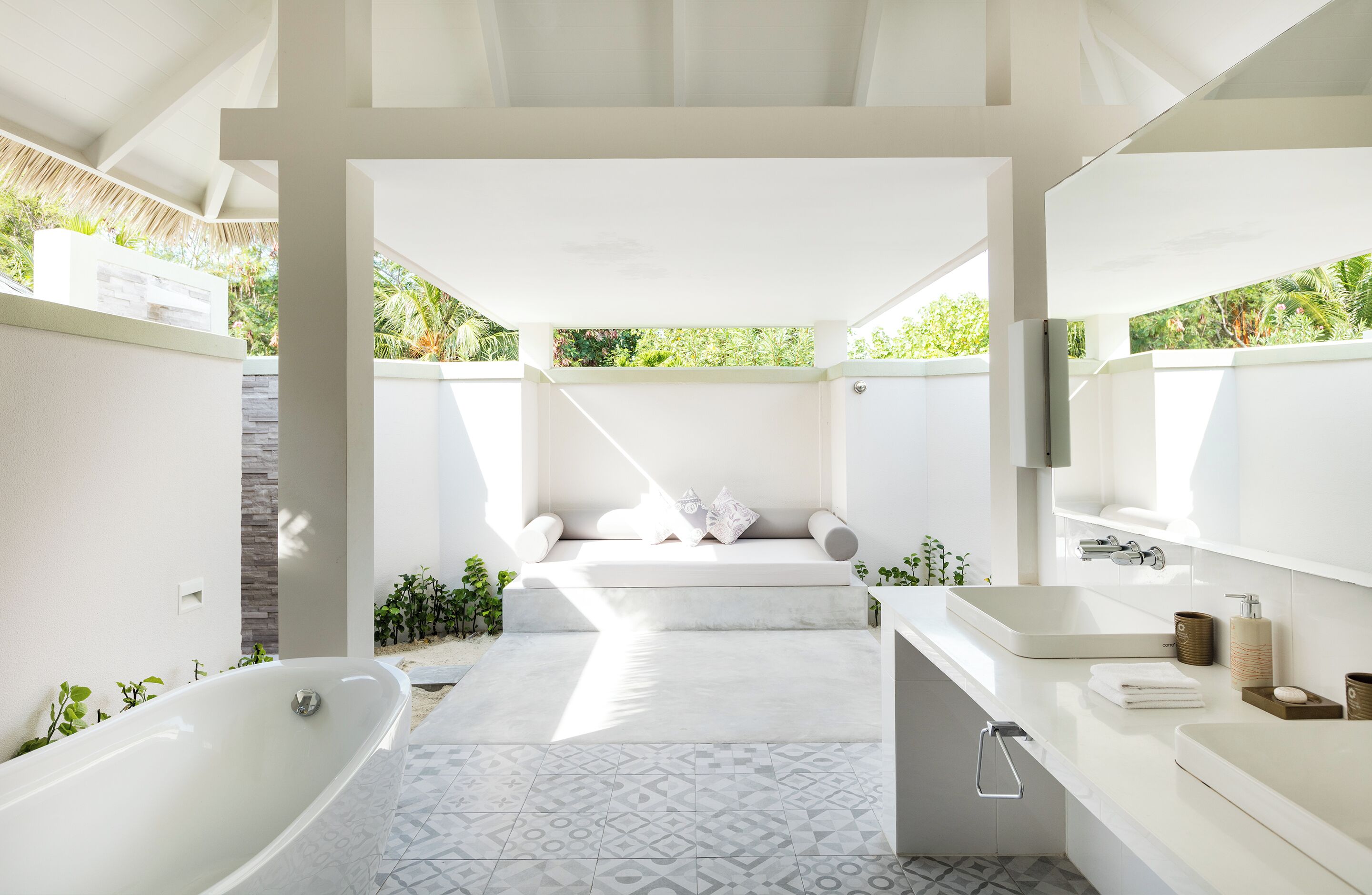A modern bathroom with a freestanding bathtub, a large sink, and a shower area.
