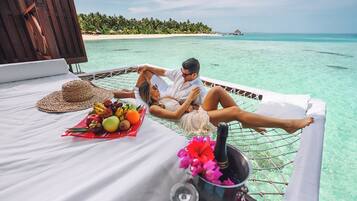 Relax in a hammock bed with a breathtaking view of the turquoise waters and tropical beach.