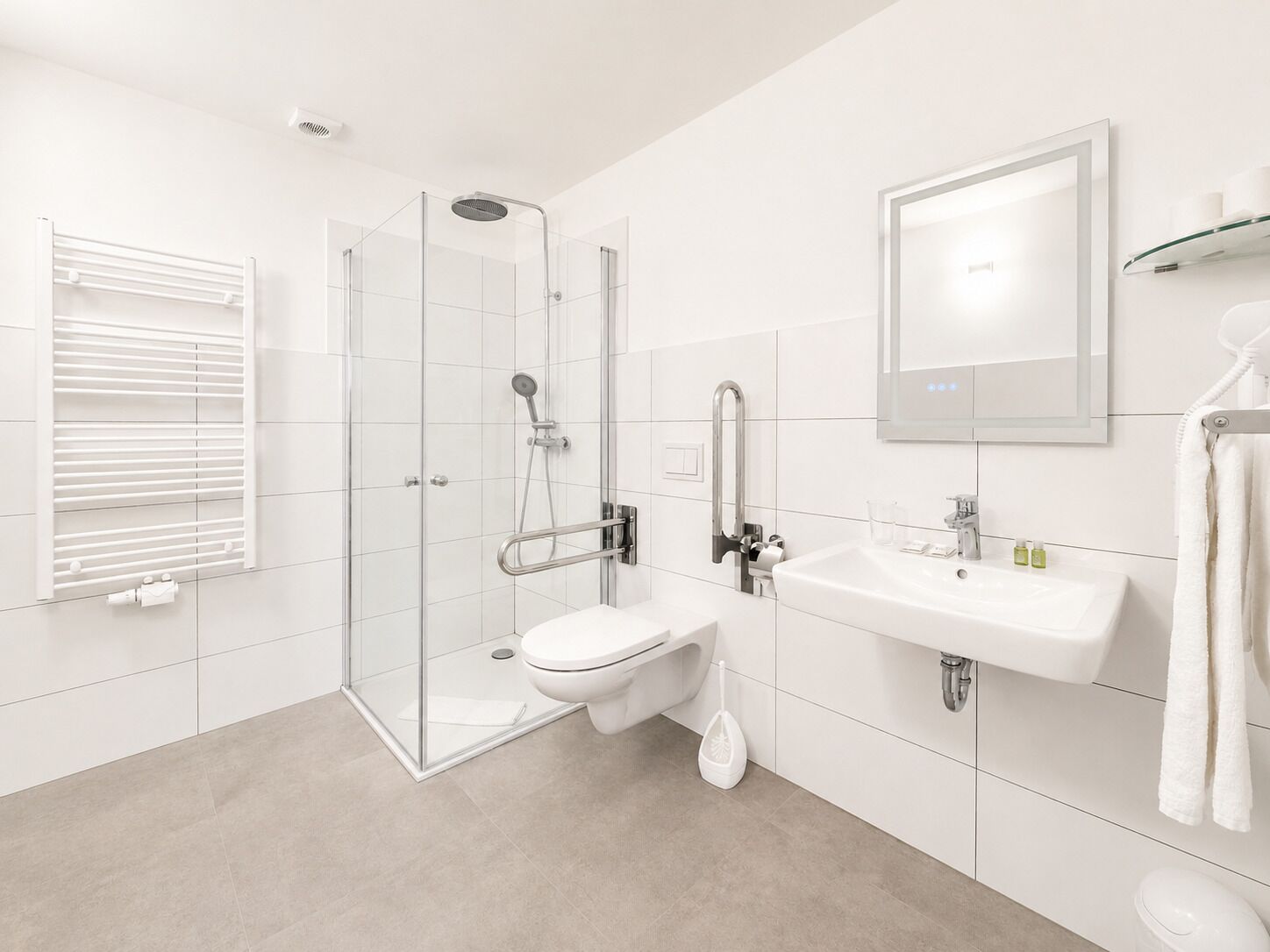 A modern bathroom with a glass shower enclosure, a toilet, a sink, and a mirror.