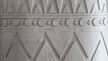 A textured wall with geometric patterns and circular motifs.