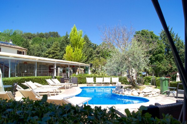 Seasonal outdoor pool, open 10:30 AM to 6:30 PM, pool umbrellas