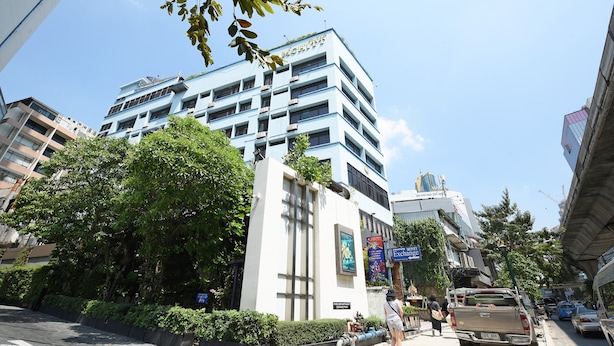A multi-story building with a sign reading "Motel".