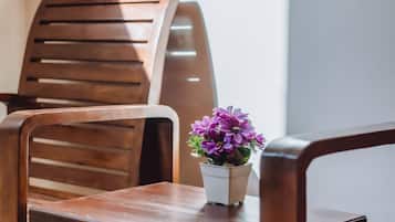 A wooden chair and table with a potted plant.