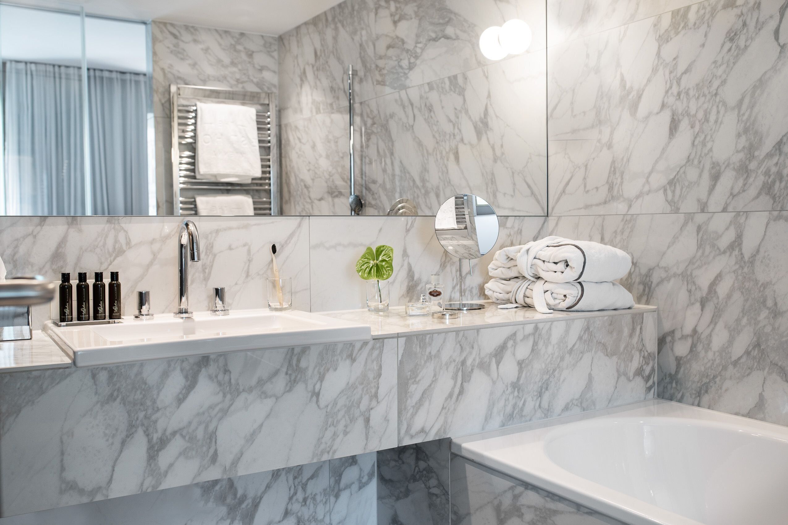 designer toiletries, hair dryer, bathrobes, slippers