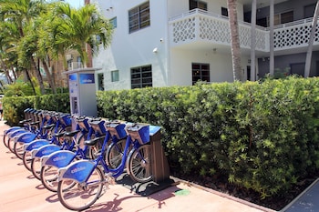 A multi-story hotel with balconies, palm trees, and a lobby area. at Hotel Gaythering - Gay Hotel - All Adults Welcome