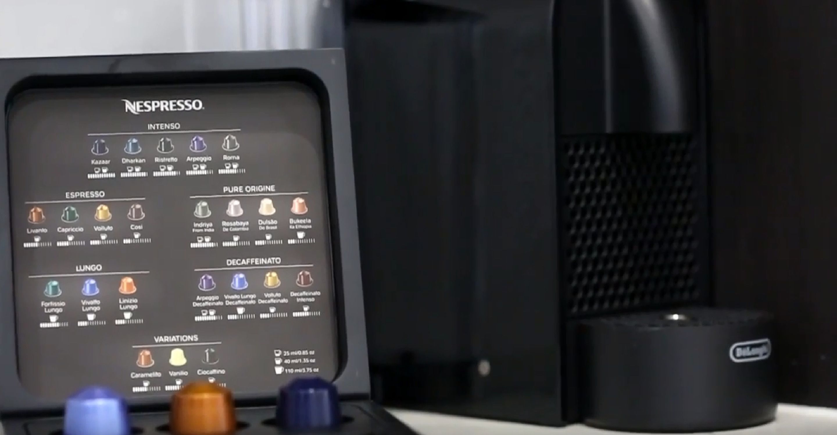 A Nespresso coffee machine with various coffee options and a Billabong water bottle.