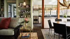 A modern kitchen with stainless steel appliances, a dining area with a round table and chairs, and a cozy living room with a sofa and decorative pillows. - Faraway Nantucket (Nantucket)