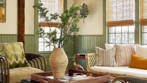 A cozy room with a rattan sofa, a wooden bench, and a wicker coffee table. - Faraway Nantucket (Nantucket)
