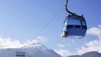 A cable car system with a clear view of a snow-capped mountain in the background.